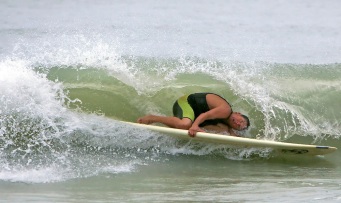 Surfer ducks under wave as hurricane approaches